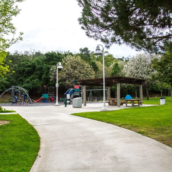 Path to a playground, swings and picnic tables