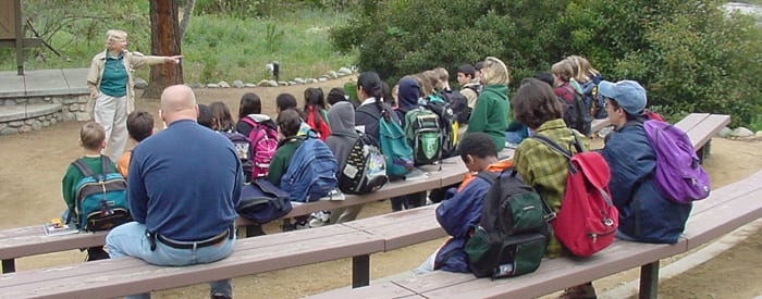 LA County volunteer speaking to group of children