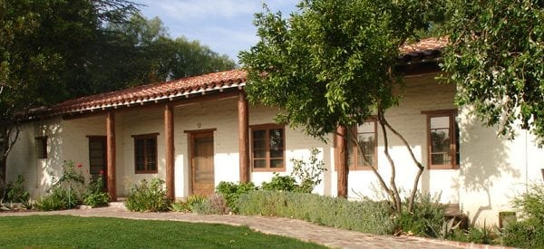 old adobe house with small garden