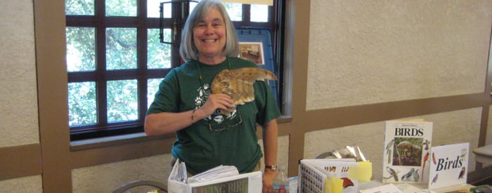 LA County volunteer with bird wing in hand