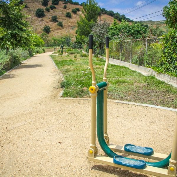 Exercise machine to the side of a dirt walkway