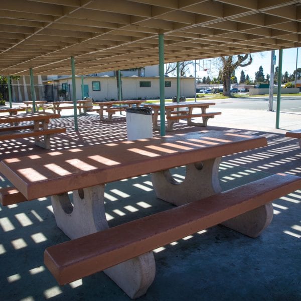 Adobe picnic tables under an awning