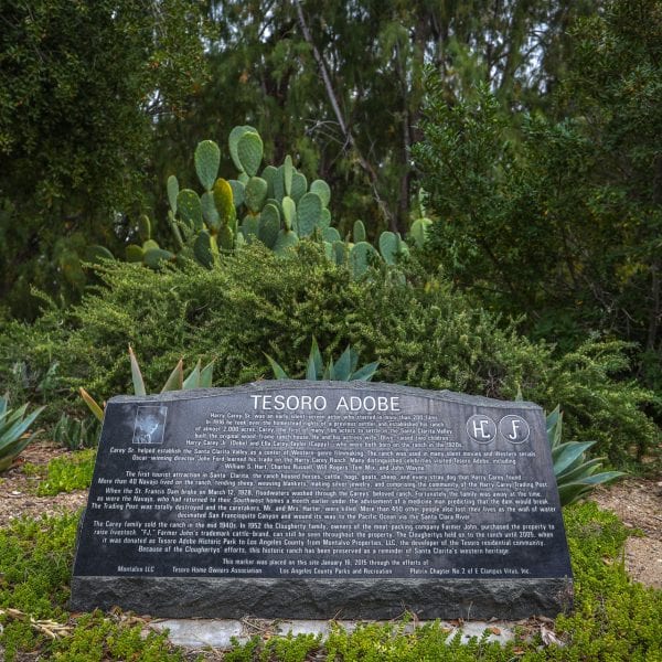 Large stone Tesoro Adobe plaque in a garden
