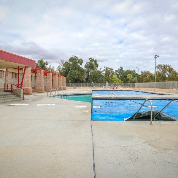 Outdoor pool next to facility