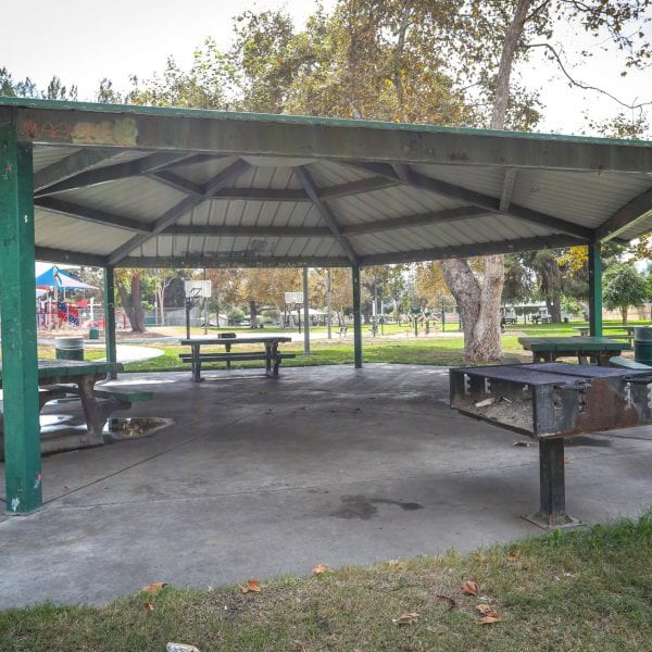 Picnic tables and BBQ grills under an awning