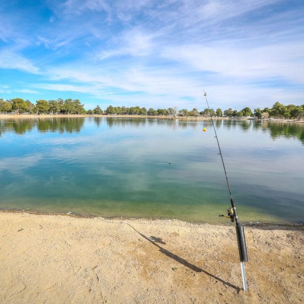 Lake with propped up fishing pole