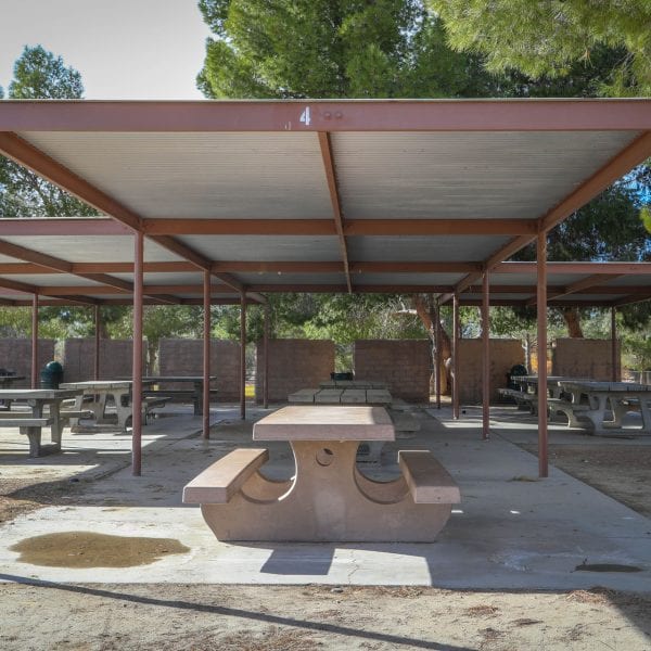 Adobe picnic tables covered by an awning