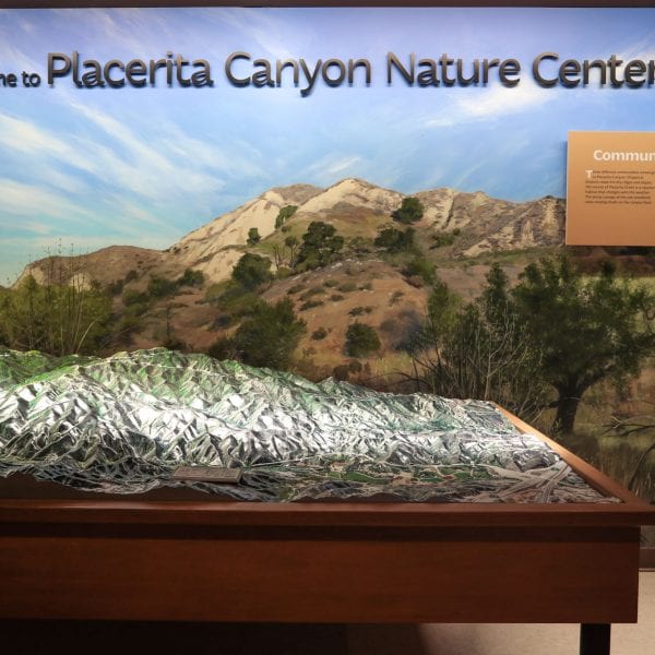 3D map of mountain range and welcome sign in the museum